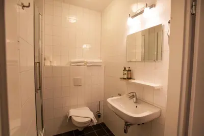 a white bathroom with a sink and a toilet at Apartment 4G in Amersfoort