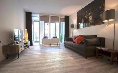 a living room with a couch and a tv at Apartment 4G in Amersfoort