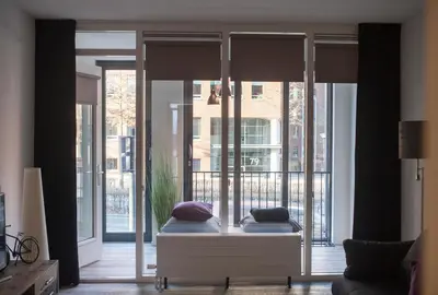 a bedroom with a bed in front of a window at Apartment 4G in Amersfoort