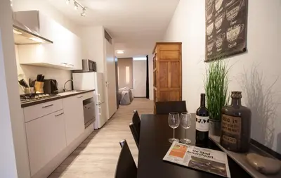 a kitchen with a table with wine bottles and glasses at Apartment 4G in Amersfoort
