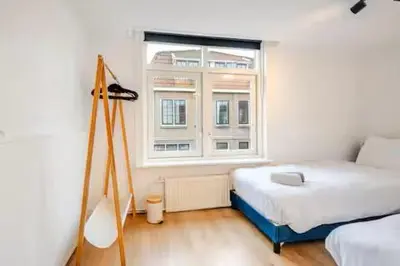 a bedroom with a bed and a window at Large Family House Alkmaar in Alkmaar