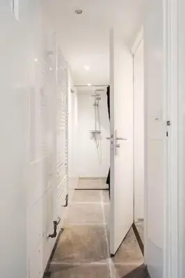a hallway with white walls and a white hallway with a hallwayngth at Large Family House Alkmaar in Alkmaar