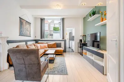 a living room with a couch and a television at Large Family House Alkmaar in Alkmaar