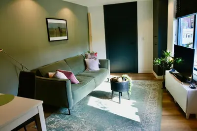 a living room with a couch and a television at Costa C en E in Noordwijk