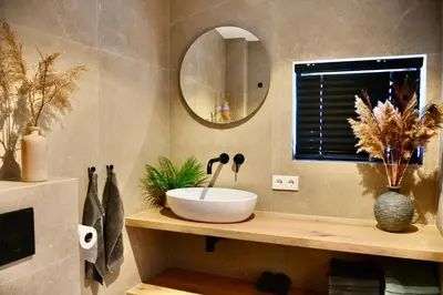 a bathroom with a bowl sink and a mirror at Costa C en E in Noordwijk