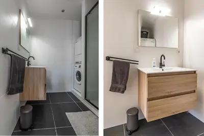 a bathroom with a sink and a washing machine at Panoramic canalview apartment in Amsterdam