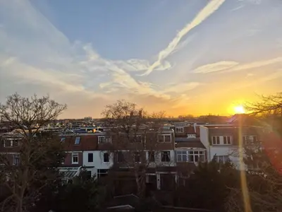 a sunset over a city with houses at Appartement Zijlweg in Haarlem