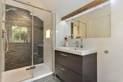 a bathroom with a sink and a shower at Boerderijwoning 't Trogje in Heiloo