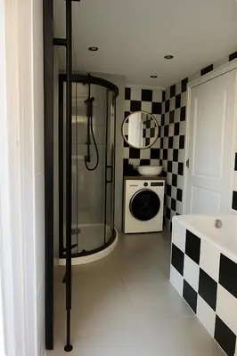 a bathroom with a shower and a washing machine at Canal House The Manor in Amsterdam