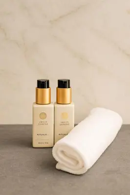 two bottles of soap next to a towel at Canal House The Manor in Amsterdam