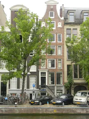 a group of cars parked in front of a building at Canal House The Manor in Amsterdam