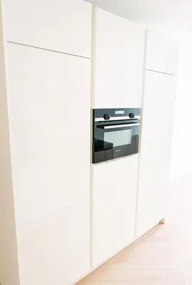 a kitchen with white cabinets and a stove at Canal House The Manor in Amsterdam