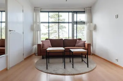 a living room with a couch and a table at De Schelp 66, Free parking in Zandvoort