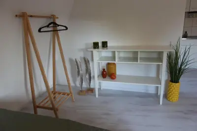 a room with a white shelf and a tripod at Viva la Vida in Bergen