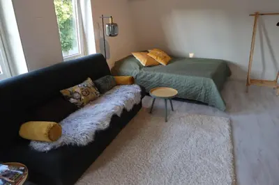 a living room with a couch and a bed at Viva la Vida in Bergen