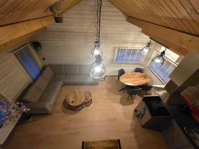 an overhead view of a living room with a table and chairs at leuke gezellige blokhut in Vijfhuizen