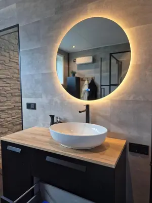 a bathroom with a white sink and a mirror at B&B Aquamarijn Katwijk in Katwijk aan Zee