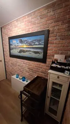 a brick wall with a painting on a wall at B&B Aquamarijn Katwijk in Katwijk aan Zee