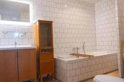 a bathroom with a tub and a sink and a toilet at T Pronkhuis in Egmond aan Zee