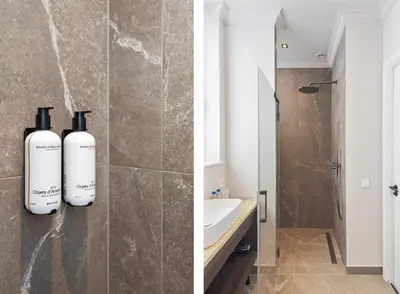 a bathroom with two bottles of wine sitting on a counter at Boutique hotel Novi in Zandvoort
