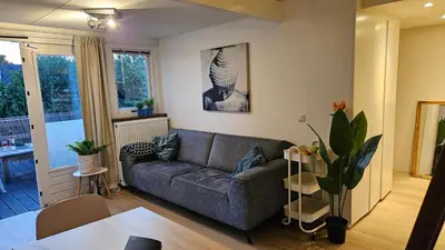 a living room with a couch and a table at Amsterdam ZaanseSchans House in Krommenie