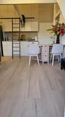 a kitchen with two white chairs and a table at Amsterdam ZaanseSchans House in Krommenie