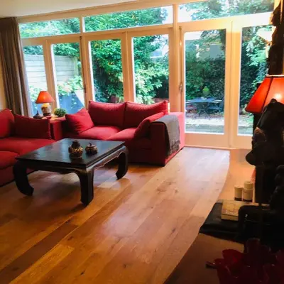 a living room with a red couch and a coffee table at Treasure in Amsterdam