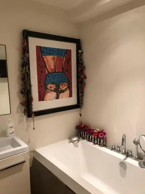 a bathroom with a sink and a picture on the wall at Treasure in Amsterdam