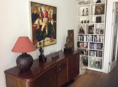 a room with a table with a lamp and a book shelf at Treasure in Amsterdam