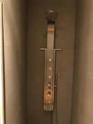 a shower stall with a shower head in a bathroom at Treasure in Amsterdam