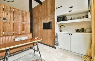 a kitchen with a bench and a table in a room at Studio Pien Zandvoort in Zandvoort
