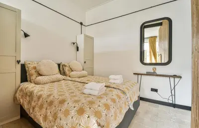 a bedroom with a bed and a mirror at Studio Pien Zandvoort in Zandvoort