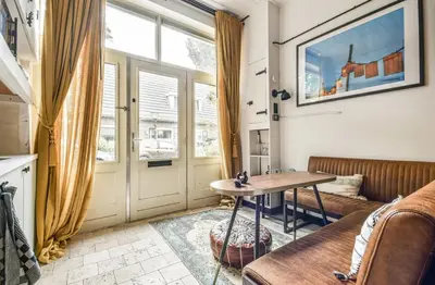 a living room with a table and a couch at Studio Pien Zandvoort in Zandvoort