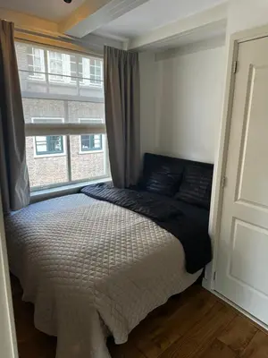a bedroom with a bed and a window at Boutique LaBeau in Amsterdam