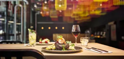 a table with a plate of food and a glass of wine at Jaz in the City Amsterdam in Amsterdam