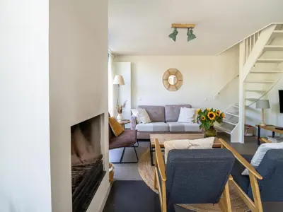 a living room with a couch and a fireplace at Holiday home Waterland for six Person in Egmond aan den Hoef