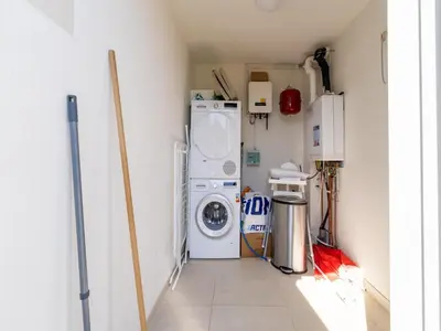 a laundry room with a washer and dryer at Holiday home Waterland for six Person in Egmond aan den Hoef