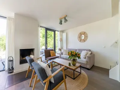 a living room with a couch and a table at Holiday home Waterland for six Person in Egmond aan den Hoef