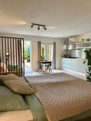 a bedroom with a large bed and a table at Zeegroen in Zandvoort
