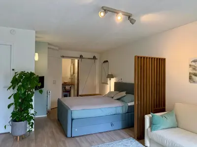 a bedroom with a bed and a couch at Zeegroen in Zandvoort