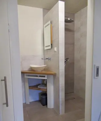 a bathroom with a sink and a shower at Zeegroen in Zandvoort