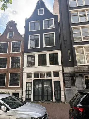 a white car parked in front of a building at History and luxury in Amsterdam