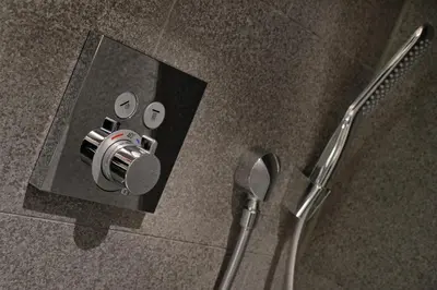 a glass shower stall with a shower head and a shower at Amsterdam Forest Hotel in Amstelveen