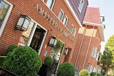 a brick building with a sign on the front of it at Amsterdam Forest Hotel in Amstelveen