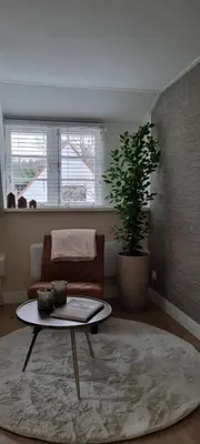 a living room with a couch and a coffee table at Puur Schoorl in Schoorl