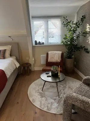 a living room with a bed and a coffee table at Puur Schoorl in Schoorl