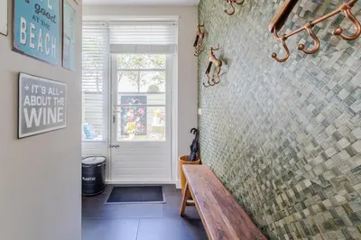 a bathroom with a bench and a walk in shower at Puur Schoorl in Schoorl