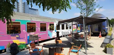 a pink train is parked at a train station at Train Lodge Amsterdam in Amsterdam