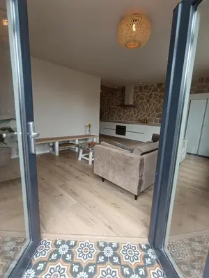 a view of a living room with a couch at Mediterranean apartment with home theater in Bodegraven