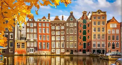 a group of buildings next to a body of water at Mediterranean apartment with home theater in Bodegraven